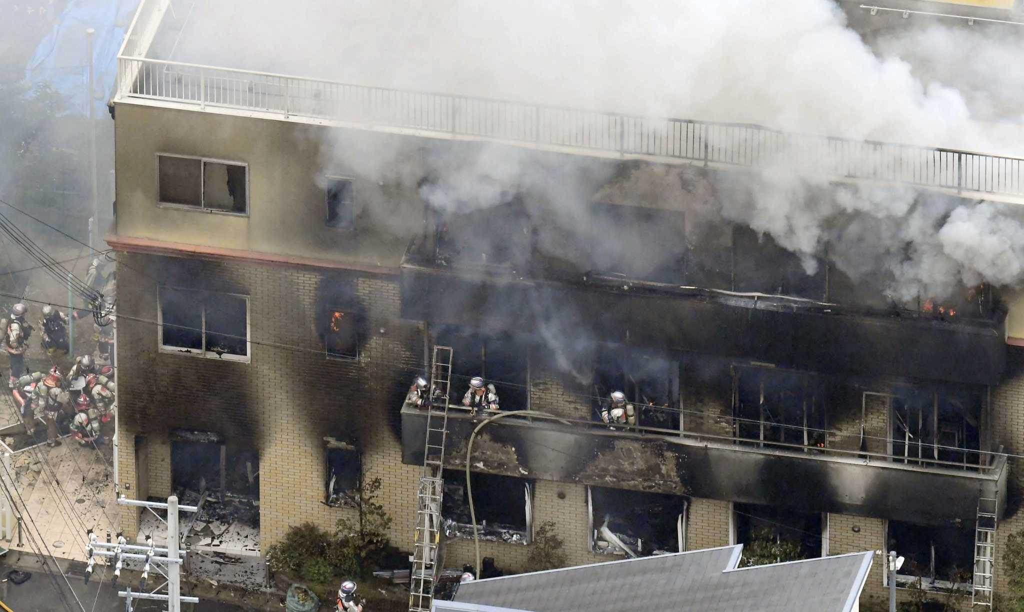 Firefighters respond to a building fire of Kyoto Animation in Kyoto, western Japan, Thursday, July 18, 2019. The fire broke out in the three-story building in Japan's ancient capital of Kyoto, after a suspect sprayed an unidentified liquid to accelerate the blaze, Kyoto prefectural police and fire department officials said.(Kyodo News via AP)