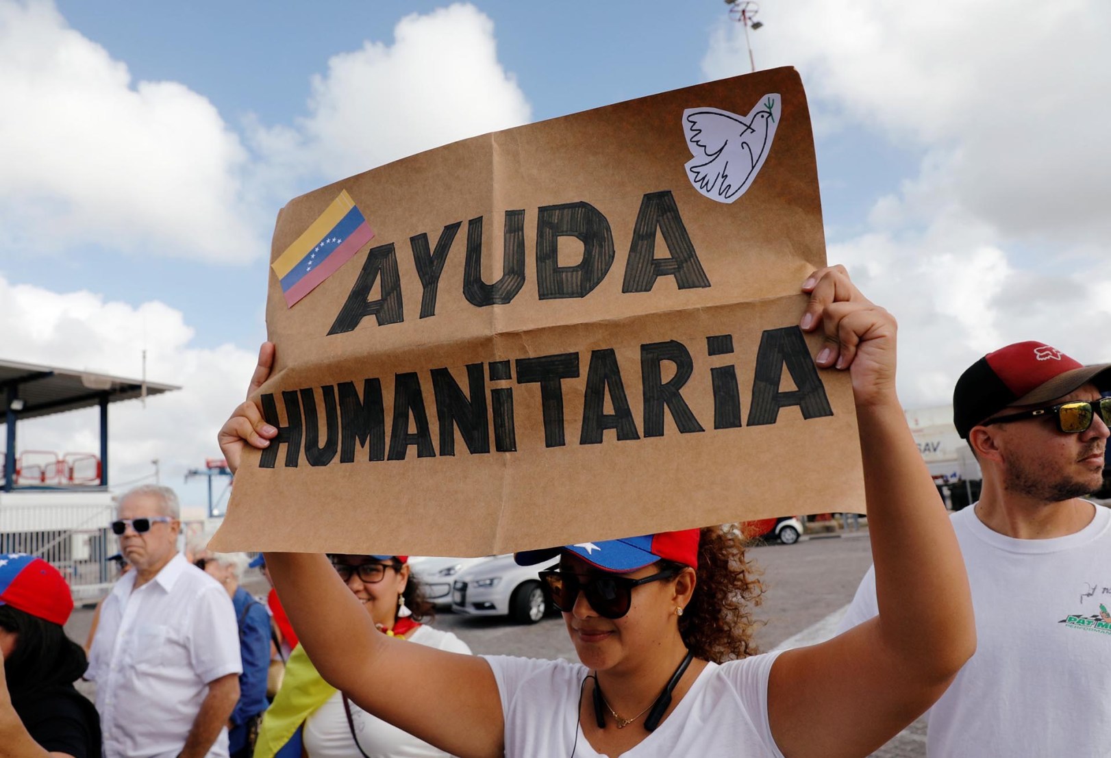 Supporters of Venezuela's opposition leader Juan Guaido hold flags and signs backing the humanitarian aid at the port in Willemstad on the island of Curacao, February 23, 2019. REUTERS/Henry Romero