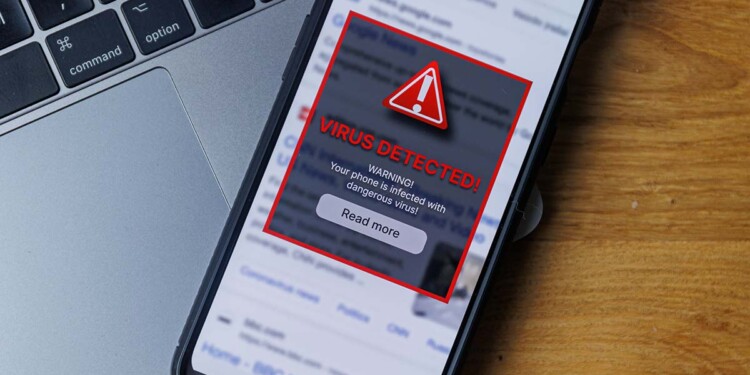 Virus warning notification on phone screen. Dangerous malware virus in phone Concept. High quality photo