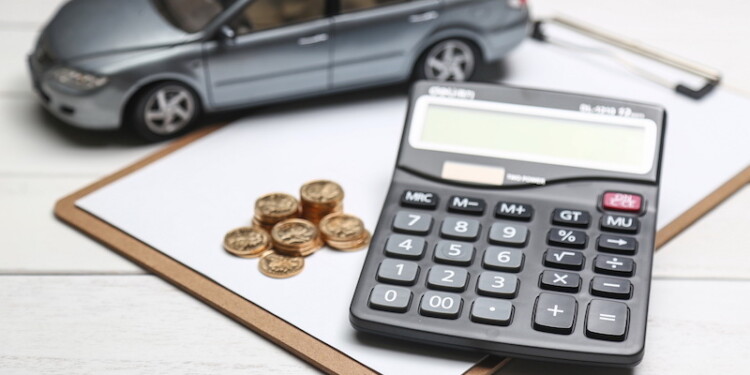 car model,calculator and coins on white table